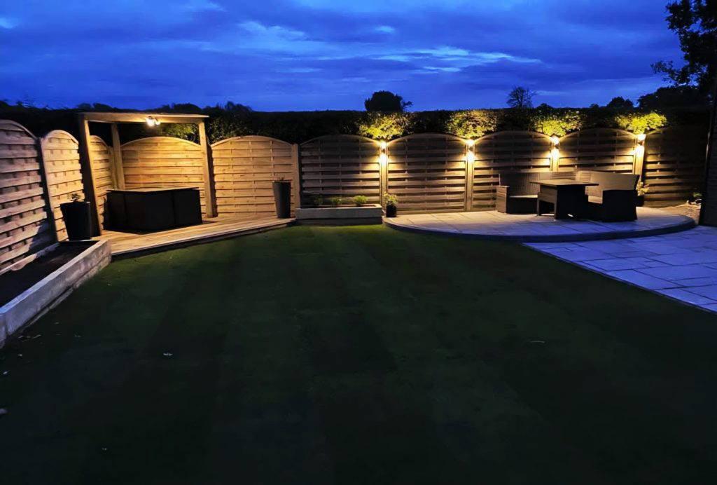 An image of a Gloss 'n' Gardens project done for a client. There is new sod laid out in the yard, and a new stone patio.