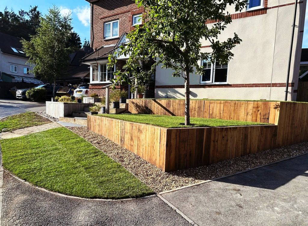 An image of a Gloss 'n' Gardens project done for a client. The front yard is newly done with new sod and elevated woodwork.
