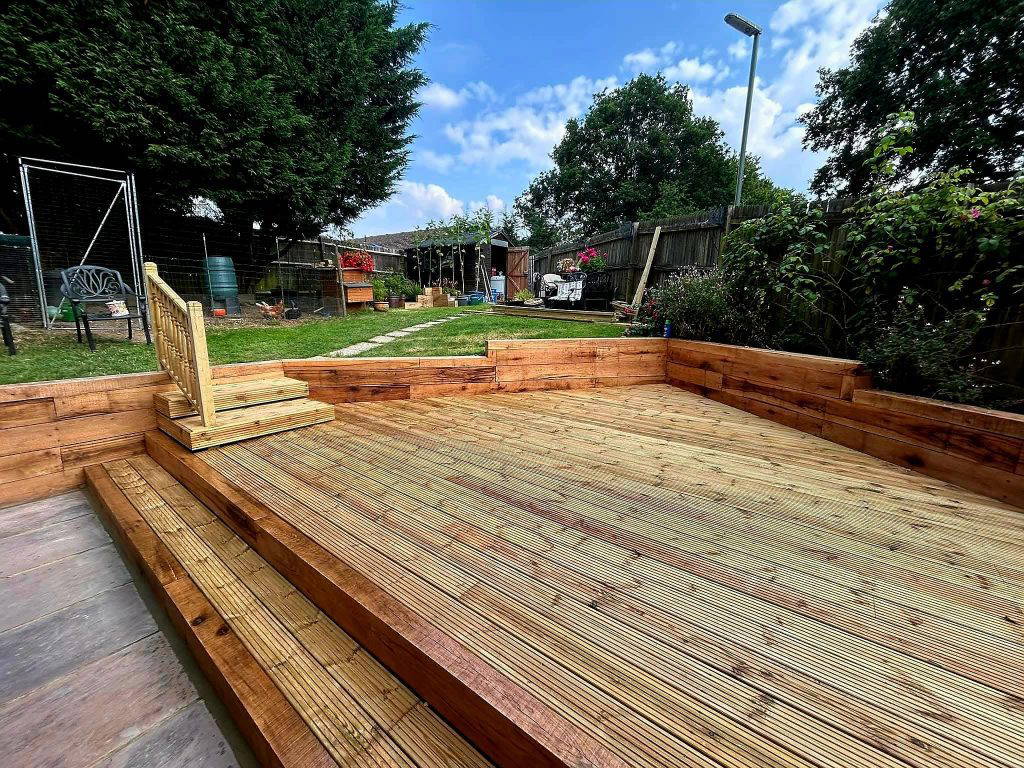 An image of a Gloss 'n' Gardens project done for a client. There is newly built deck that leads to a garden.